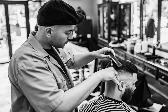 Classic haircut in a barbershop. Curve hair styling and hair health care in a barbershop. 