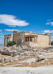 Obraz premium Athens, Greece. Erechtheion with Caryatid Porch on Acropolis hill, blue sky background