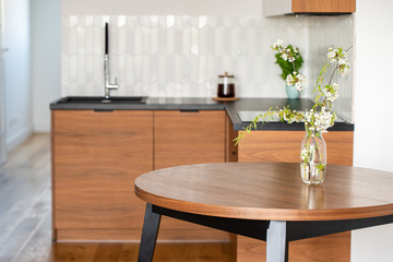 Wooden white-brown kitchen with a black countertop