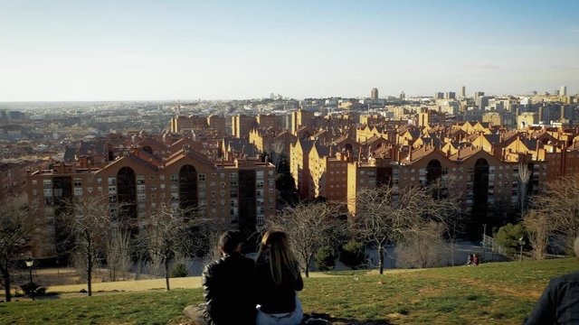 Enjoying sunset and sports at park with Madrid, Spain skyline in the background