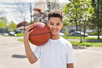 cute Afro american players playing basketball outdoors