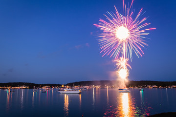 Boats in the harbor during fireworks display, slow shutter, motion blur

