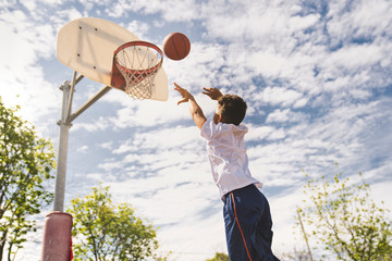 cute Afro american players playing basketball outdoors
