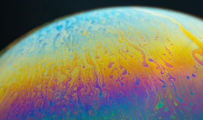 iridescent rainbow on the surface of a soap bubble sphere