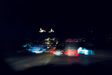 Speeding on the road at night.