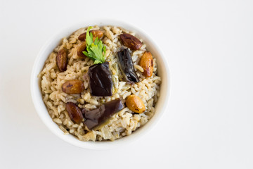 Traditional Turkish Islamic Sacrifice Feast Food is cooked rice with eggplant,fresh almond nuts and onion.Top view.