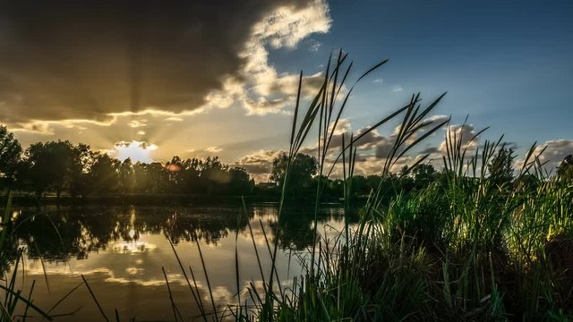 Sunset at fishing pond Meerse Kamp near the village of Stevensweert in the southern province of Limburg, The Netherlands.