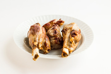 Two shanks,bony meat in the white plate,grilled (searing) in the pan before main cook.Sacrifice Feast Concept