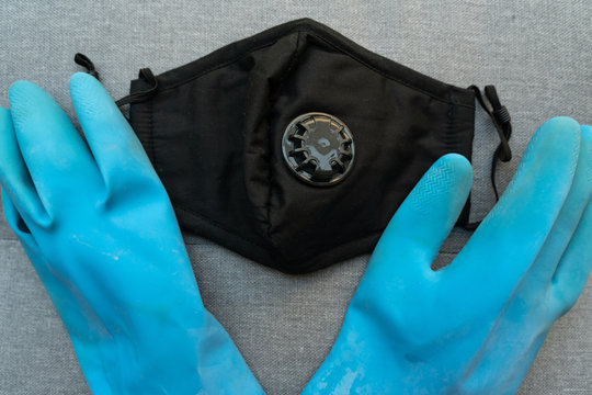 Blue gloves and black facemark ready to be worn during the coronavirus pandemic 
