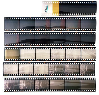 set of real long 35mm positive strips on white background, contact sheet with empty frames or film cells.
