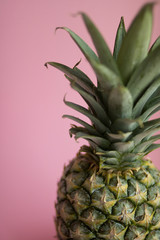 Beautiful tasty fresh pineapple on a delicate pink background
