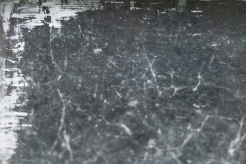 Old gray scary spider web on black window against dark background