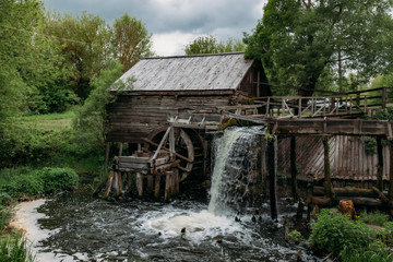 Old wooden log watermill in Russian village
