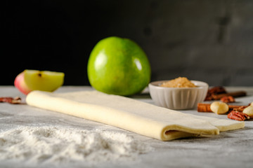Raw dough for apple pie on a dark background. Hight quality photo
