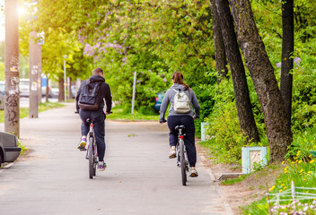 Cyclists ride on the bike path in the city street