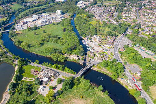Aerial drone photo of the beautiful town of Mirfield in Kirklees, West Yorkshire, England showing the train track going over the river on a beautiful sunny summers day