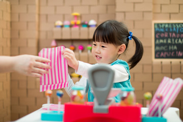 toddler girl pretend play sweet shop keeper at home