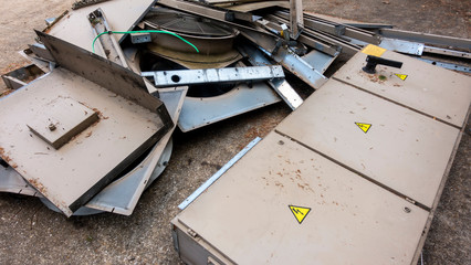 Decommissioned industrial water chiller unit laying in a pile of scrap
