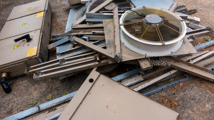Dismantled industrial chiller laying in a heap of scrap
