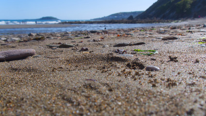 View across a sand and pebble beach to the sea, Cornwall UK