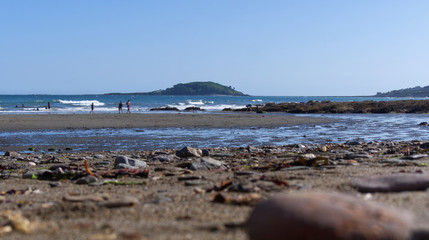 Fototapeta na wymiar View across a sand and pebble beach to the sea, Cornwall UK