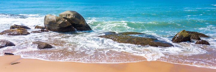 Tropical beach with panoramic views and waves, rocks and sand background. Travel destinations in Brazil and banner web.