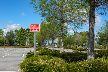 A faculty parking sign in a parking lot © Joni