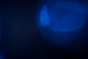 Dark background with faint blue bokeh lights for light leaks and overlays