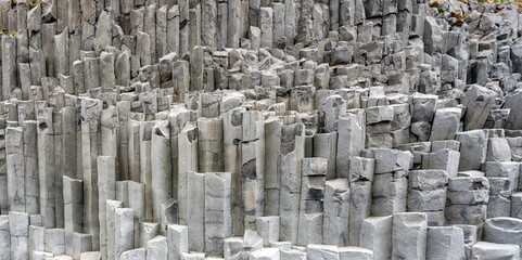 Pano and closeup of volcanic basalt rock spires from Reynisfjara beach in Iceland.