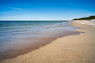 sandy and deserted beach by the summer sea