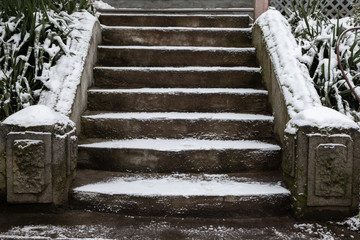 Old concrete stairs covered in freshly fallen snow © Peter