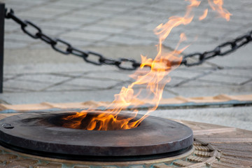 Bright orange flame in fire pit at Arc de Triomphe