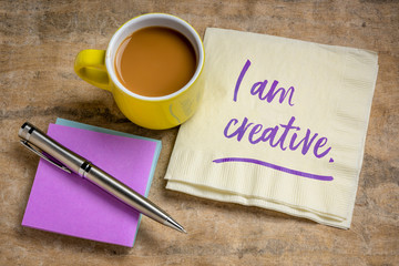 I am creative positive affirmation - handwriting on a napkin with coffee, creativity and personal development concept