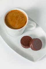Cup of coffee and chocolate cookies isolated