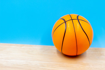 Basketball is on wooden floor on  blue background
