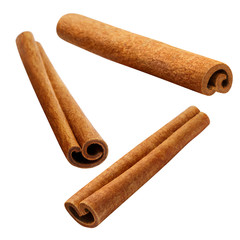 Flying delicious cinnamon sticks, isolated on white background