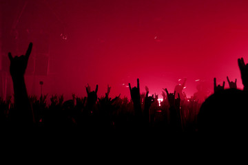 Fans hands up copy space. Red rock poster background. Life style place for text. Metal vestival...