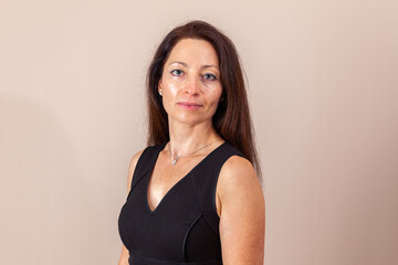 Obraz premium pretty women with long hair in black dress studio portrait.