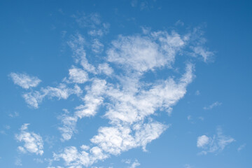 Fototapeta na wymiar the blue sky with clouds looking like a running man