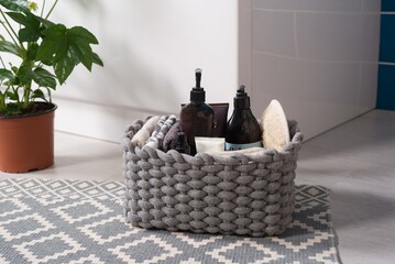 Closeup of toiletries in a yarn basket on the floor