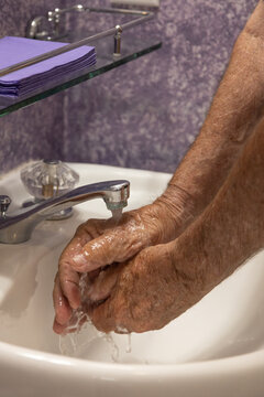 Hands under running water faucet water dripping