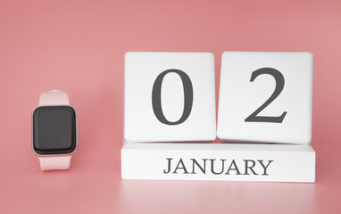 Modern Watch with cube calendar and date 02 january on pink background. Concept winter time vacation.