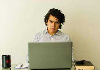 guy wearing white shirt working in laptop