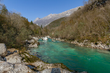 Fototapeta na wymiar Kobarid, Slovenia - October 28, 2014: The Soca river flows through western Slovenia and its source lies in the Julian Alps. One of the most beautiful rivers in Europa, known for its emerald color.