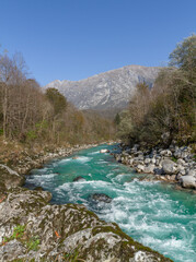 Fototapeta na wymiar Kobarid, Slovenia - October 28, 2014: The Soca river flows through western Slovenia and its source lies in the Julian Alps. One of the most beautiful rivers in Europa, known for its emerald color.