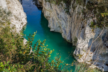 Kobarid, Slovenia - October 28, 2014: The Soca river flows through western Slovenia and its source lies in the Julian Alps. One of the most beautiful rivers in Europa, known for its emerald color.