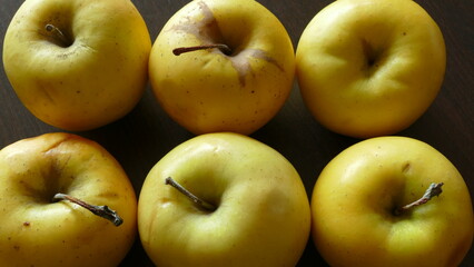 yellow apples on a dark background