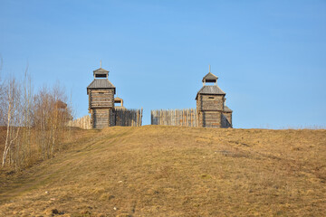 wooden fortress in the field, old Russian wooden structure, village tower in the field