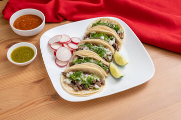Carne asada taco plate. Authentic Mexican street tacos made with marinated steak, cilantro, and diced onions, served on corn tortillas. 