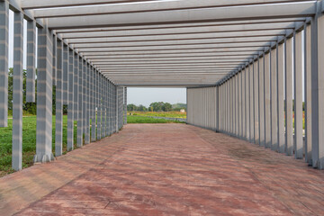 Perspective view of metal pillar corridor in park